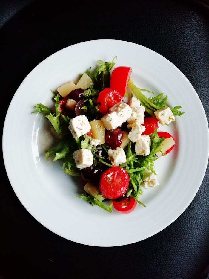 services-02 Delicious Greek salad featuring fresh vegetables and creamy feta cheese, perfect for a healthy meal.