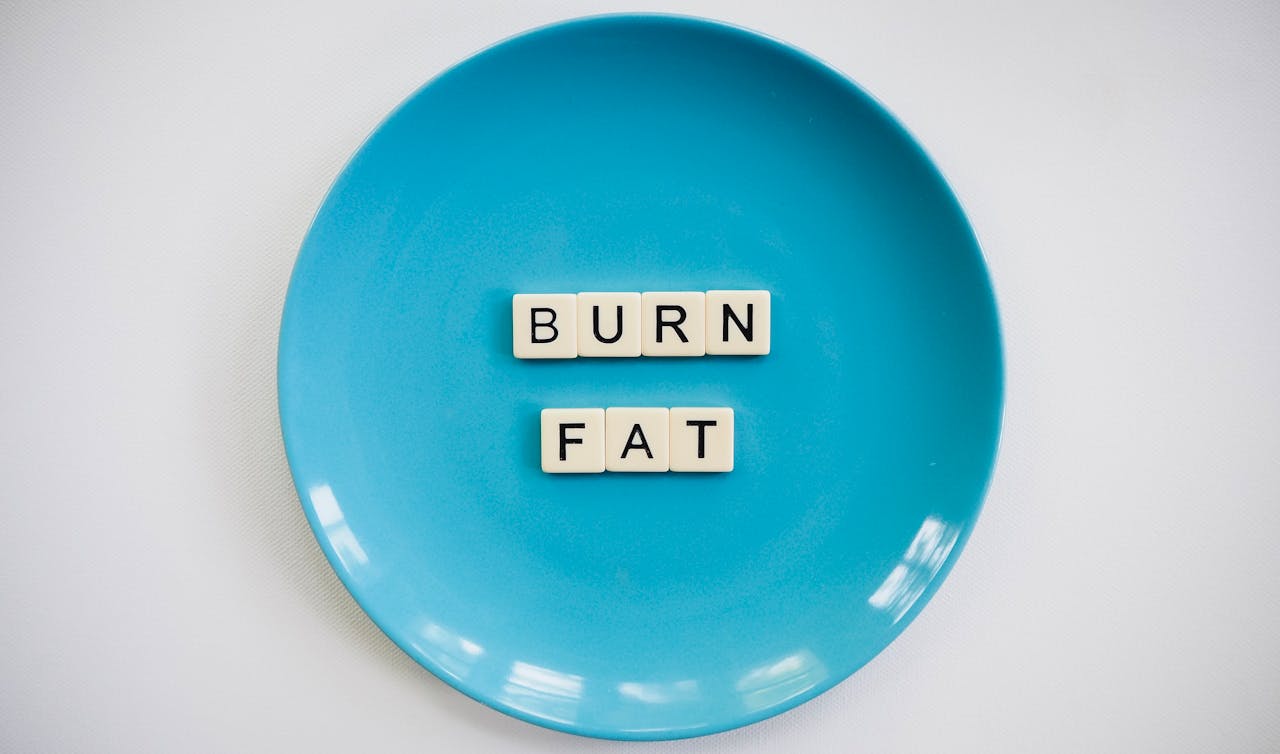 our-services-2 A conceptual image featuring the words 'Burn Fat' on a blue plate, symbolizing weight loss.